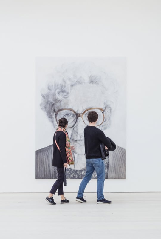 Two people looking at a painting on our wall